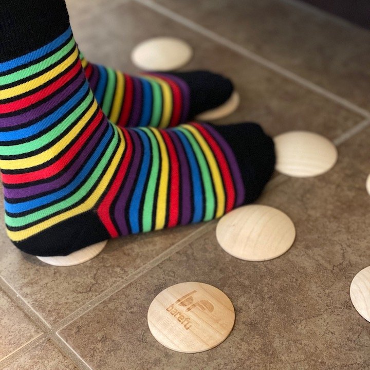 Be Lenka barefoot foot shaped socks standing on Barefu wooden floor dots