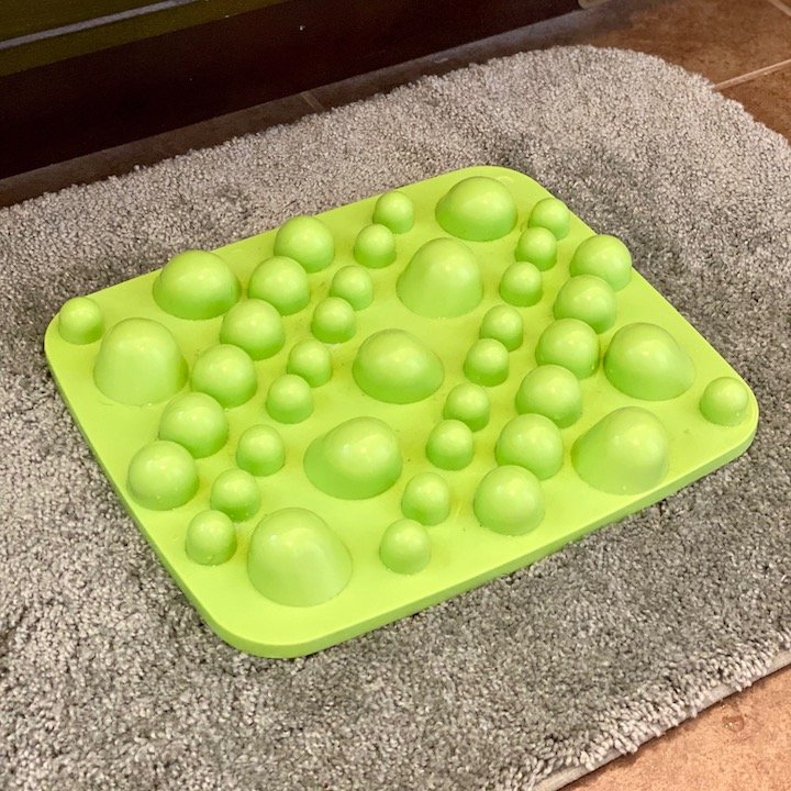 A Xero Shoes Rox Mat on top of a math rug