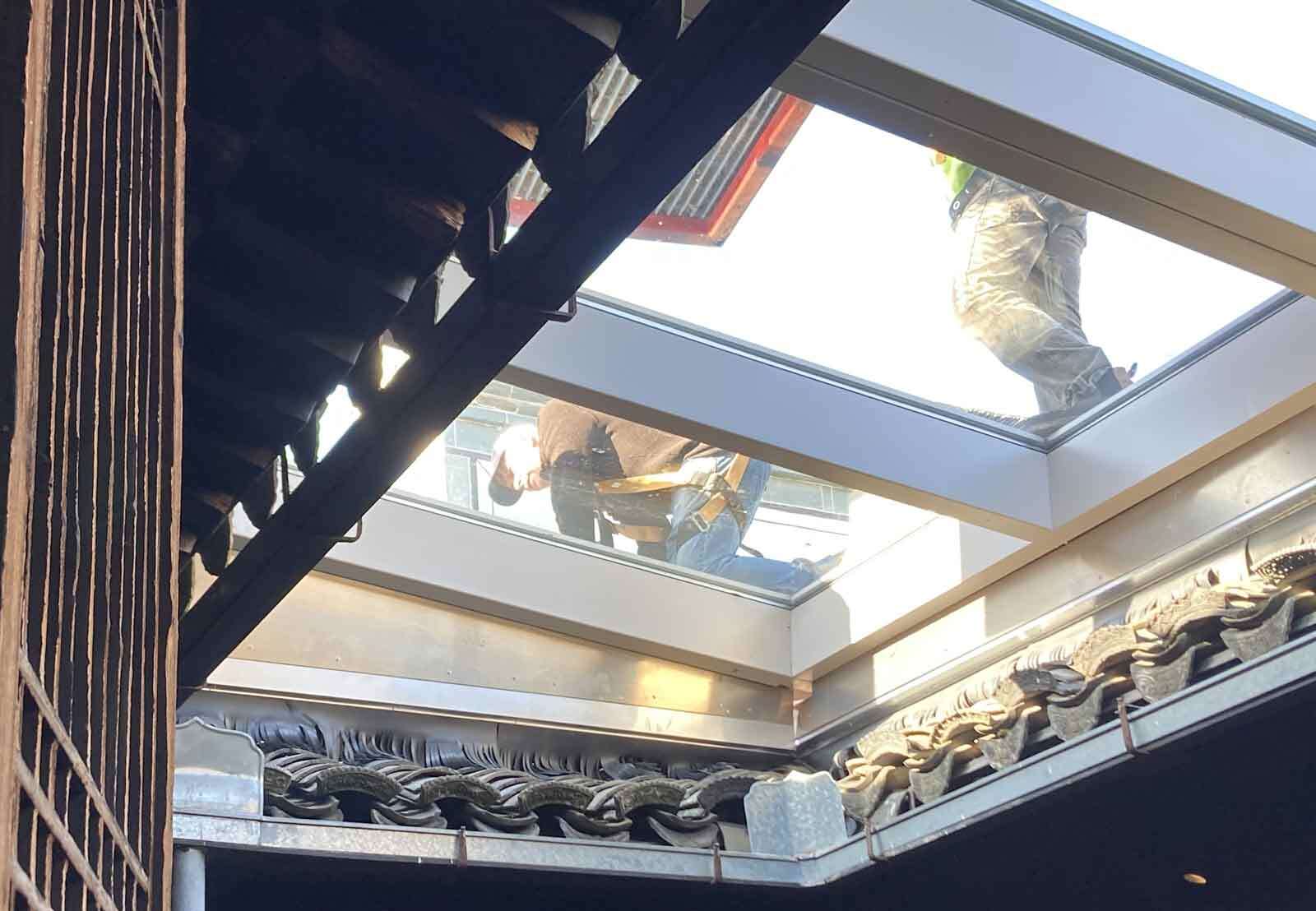 Site Superintendent, Mike Dawson, inspects the installation of the skylight panel with its new apron mockup. Photo by John G. Waite Associates, Architects.